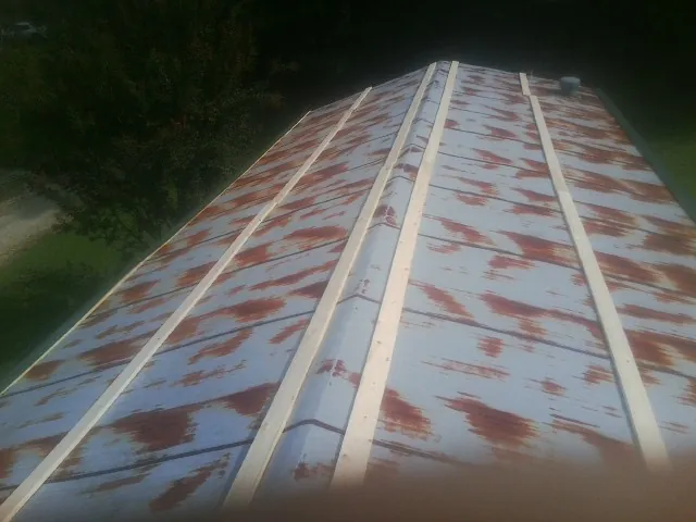 Rusted metal roof panels with new wood purlins before replacement — Storm Damage Roof Repair in Juliustown by Roofing Brothers